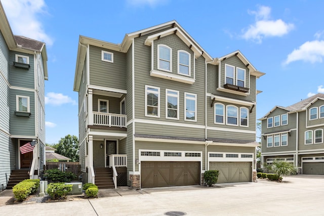 1161 Beasley Hills Ln, Houston, TX 77008 - view of property featuring a garage, a balcony, stone siding, and driveway