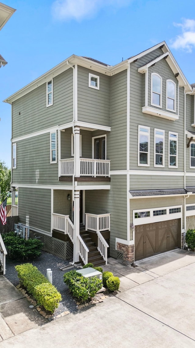 1161 Beasley Hills Ln, Houston, TX 77008 - view of front of house with a porch, a garage, concrete driveway, and a balcony