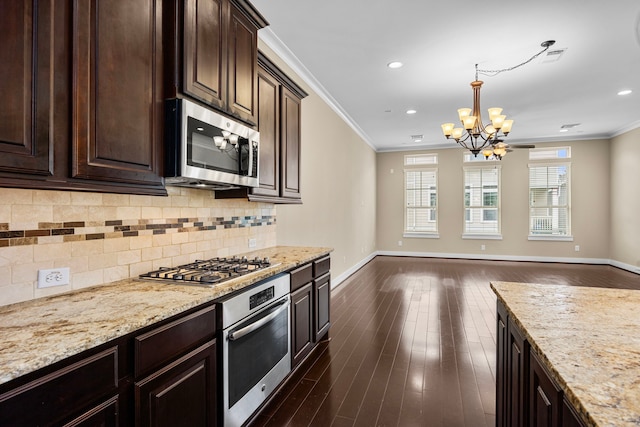 1161 Beasley Hills Ln, Houston, TX 77008 - kitchen featuring stainless steel appliances, a chandelier, ornamental molding, open floor plan, and tasteful backsplash