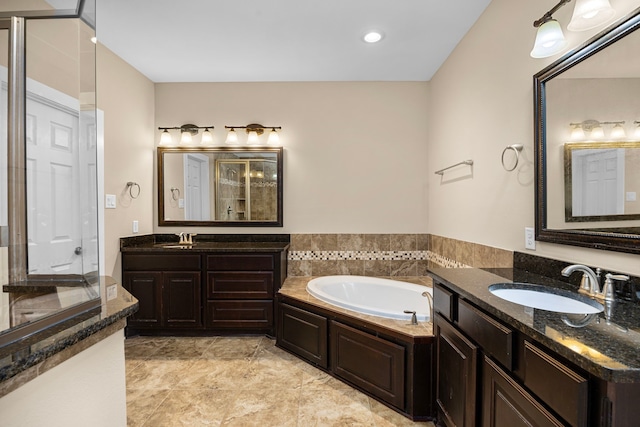 1161 Beasley Hills Ln, Houston, TX 77008 - bathroom featuring two vanities, a garden tub, a shower, and recessed lighting
