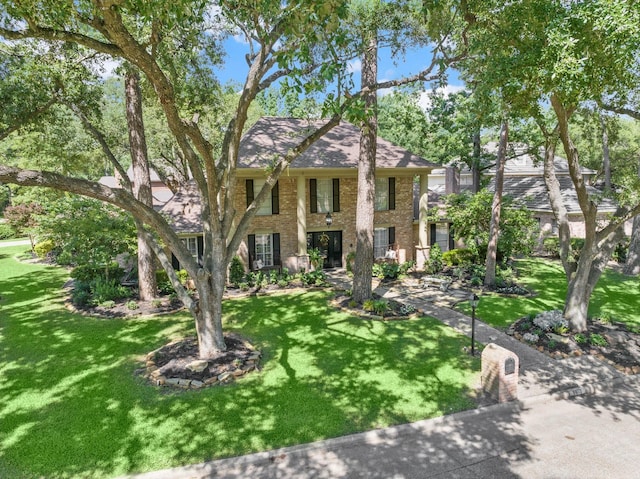 5610 Edgewick Ct, Houston, TX 77069 - view of front of home with brick siding, a front yard, and roof with shingles