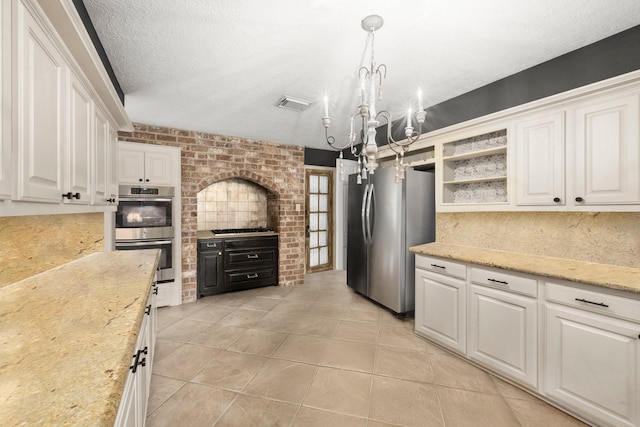 5610 Edgewick Ct, Houston, TX 77069 - kitchen featuring stainless steel appliances, white cabinets, a chandelier, light tile patterned floors, and hanging light fixtures