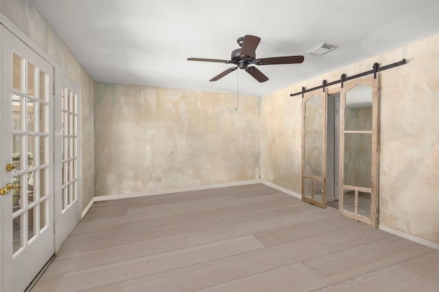 5610 Edgewick Ct, Houston, TX 77069 - empty room with wood finished floors, a ceiling fan, and a barn door