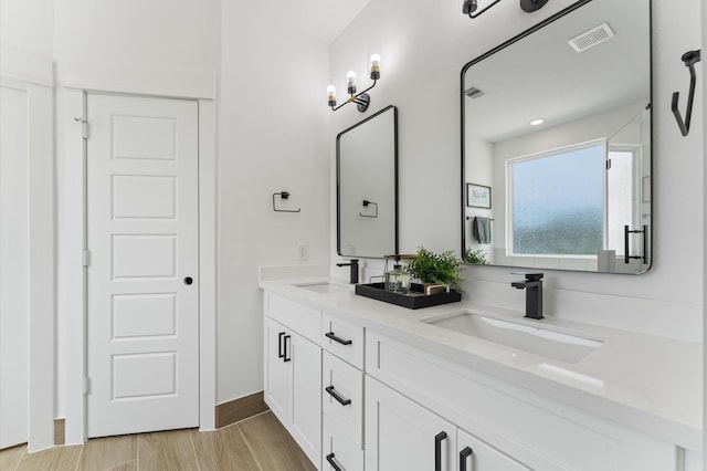8302 Springwood Canyon Ln, Houston, TX 77055 - full bathroom with double vanity and wood finished floors