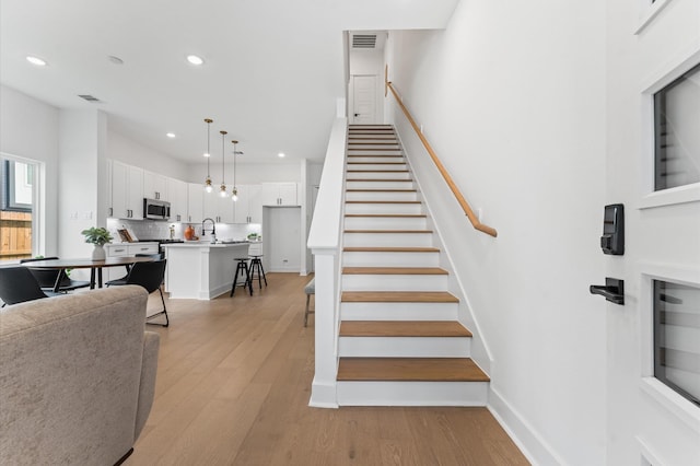 8302 Springwood Canyon Ln, Houston, TX 77055 - stairs with wood finished floors and recessed lighting