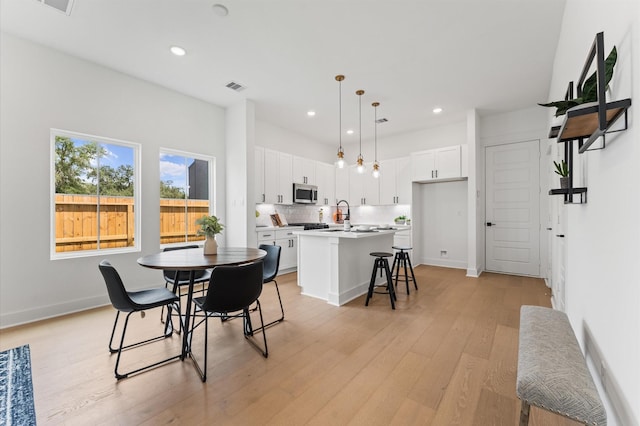 8302 Springwood Canyon Ln, Houston, TX 77055 - dining space featuring light wood-style floors and recessed lighting