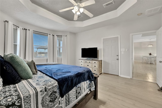 9826 Palm Dr, Mont Belvieu, TX 77523 - bedroom with a tray ceiling, light wood-style floors, and ceiling fan