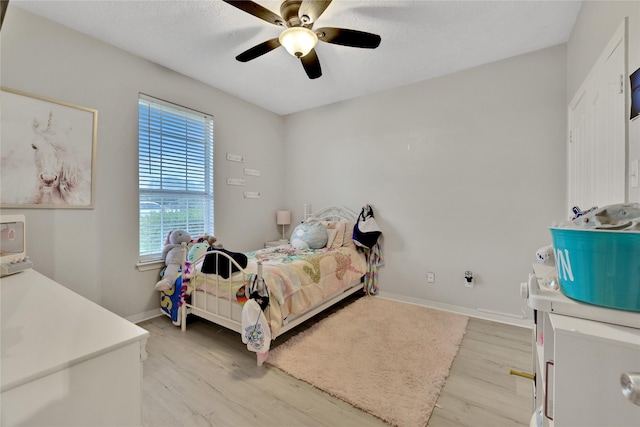 9826 Palm Dr, Mont Belvieu, TX 77523 - bedroom featuring light wood-style flooring and ceiling fan