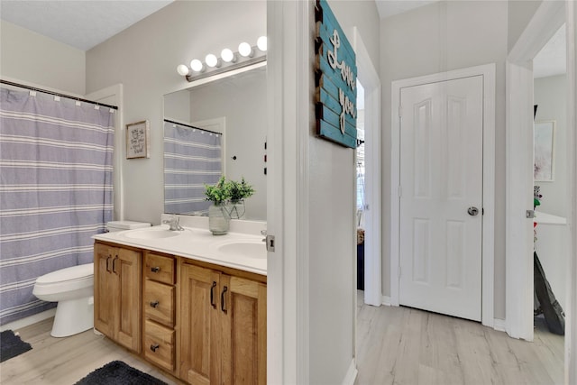 9826 Palm Dr, Mont Belvieu, TX 77523 - bathroom featuring double vanity and wood finished floors