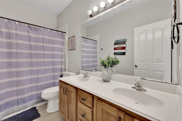 9826 Palm Dr, Mont Belvieu, TX 77523 - bathroom with double vanity and wood finished floors