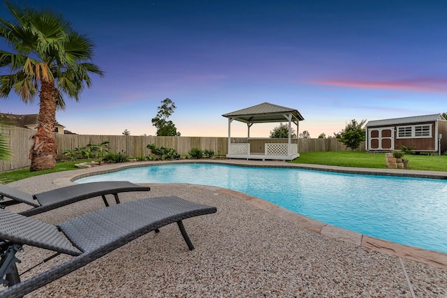 9826 Palm Dr, Mont Belvieu, TX 77523 - view of pool with a gazebo, a storage unit, and a fenced backyard