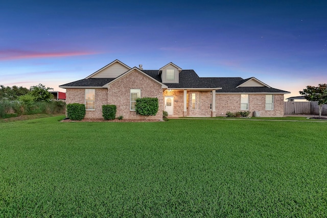 9826 Palm Dr, Mont Belvieu, TX 77523 - view of front of home with brick siding and a shingled roof