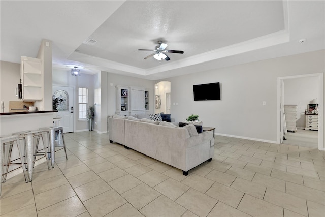 9826 Palm Dr, Mont Belvieu, TX 77523 - living room featuring a tray ceiling, ceiling fan, and light tile patterned flooring