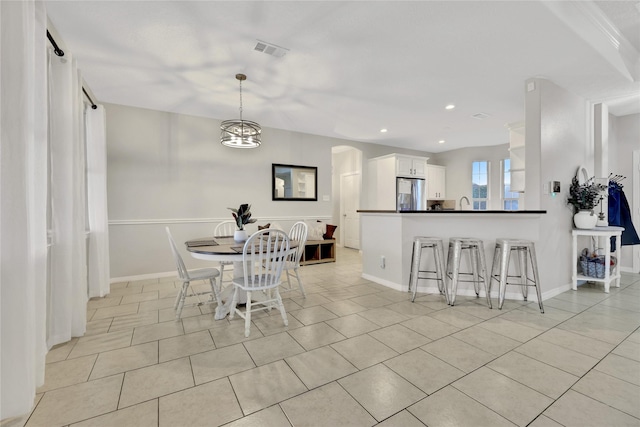 9826 Palm Dr, Mont Belvieu, TX 77523 - dining area with light tile patterned floors, recessed lighting, and a chandelier
