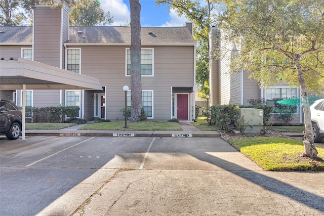 14911 Wunderlich Dr Unit 613, Houston, TX 77069 - view of front of property featuring covered and uncovered parking, a chimney, and roof with shingles