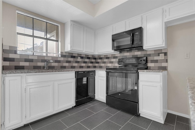 14911 Wunderlich Dr Unit 613, Houston, TX 77069 - kitchen featuring black appliances, white cabinetry, tasteful backsplash, and dark tile patterned flooring