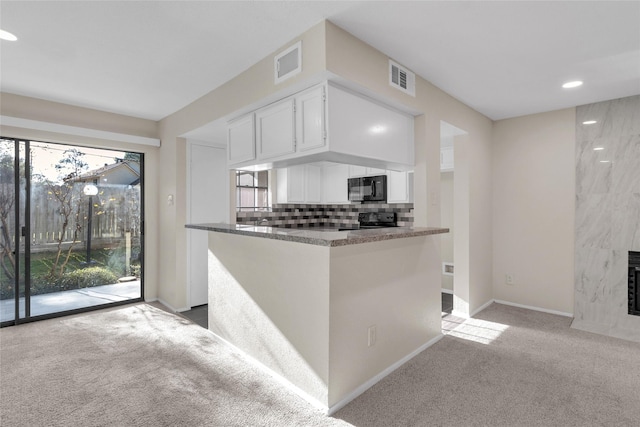 14911 Wunderlich Dr Unit 613, Houston, TX 77069 - kitchen with black appliances, carpet, white cabinetry, healthy amount of natural light, and recessed lighting
