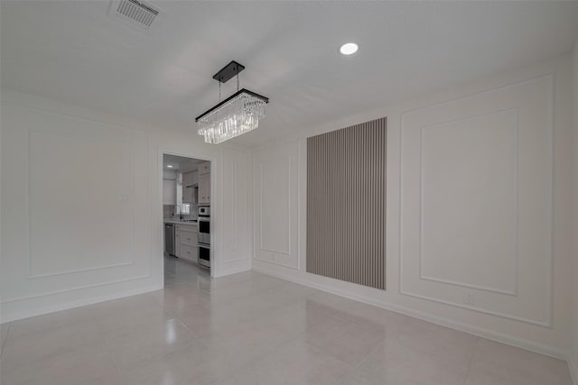 19502 Enchanted Oaks Dr, Spring, TX 77388 - unfurnished dining area featuring a decorative wall, a chandelier, light tile patterned flooring, and recessed lighting