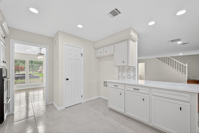 19502 Enchanted Oaks Dr, Spring, TX 77388 - kitchen featuring white cabinetry, light countertops, backsplash, a peninsula, and recessed lighting