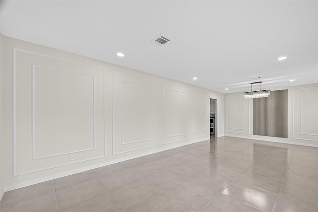19502 Enchanted Oaks Dr, Spring, TX 77388 - empty room with a decorative wall, recessed lighting, and light tile patterned floors