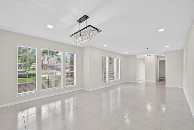 19502 Enchanted Oaks Dr, Spring, TX 77388 - spare room featuring plenty of natural light, light tile patterned floors, recessed lighting, a textured ceiling, and a chandelier