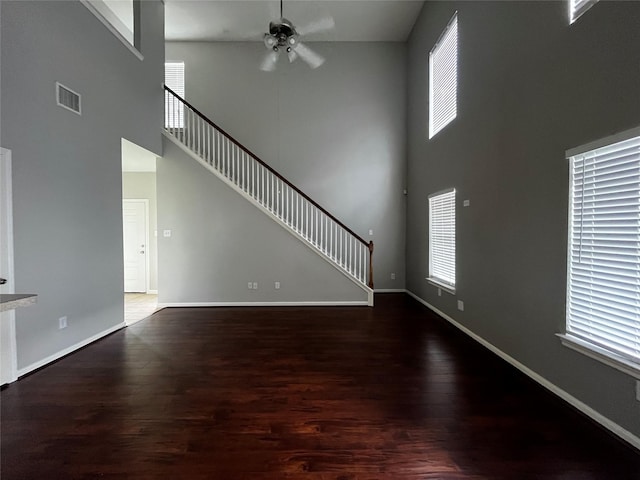 8303 Gros Ventre Ln, Houston, TX 77095 - unfurnished living room with a towering ceiling, ceiling fan, wood finished floors, and stairway