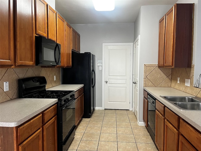 8303 Gros Ventre Ln, Houston, TX 77095 - kitchen with black appliances, light tile patterned floors, decorative backsplash, light countertops, and brown cabinets