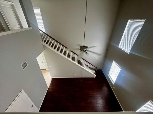 8303 Gros Ventre Ln, Houston, TX 77095 - staircase with a ceiling fan, wood finished floors, and a high ceiling