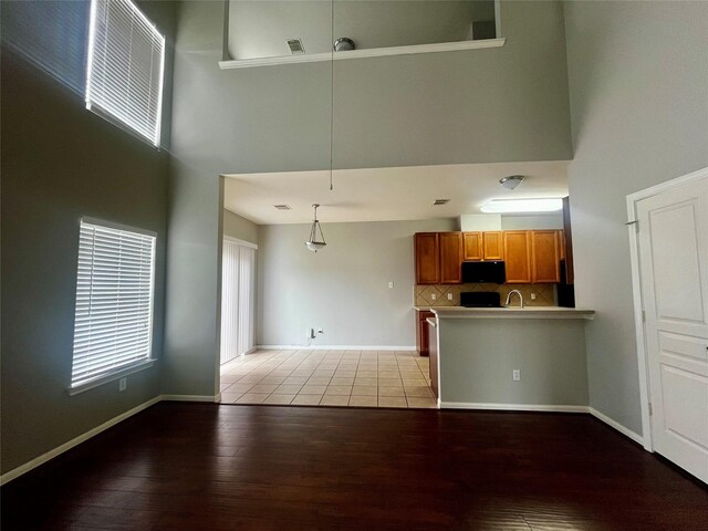 8303 Gros Ventre Ln, Houston, TX 77095 - unfurnished living room featuring a towering ceiling and light wood-style floors