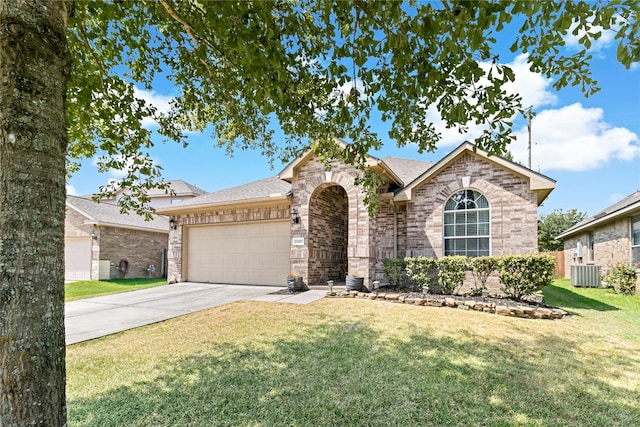 23307 W Pine Ivy Ln, Tomball, TX 77375 - view of front of house featuring an attached garage, concrete driveway, brick siding, a front yard, and roof with shingles