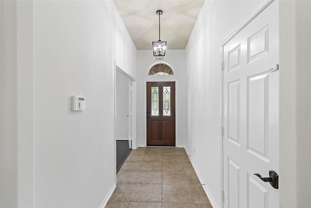 23307 W Pine Ivy Ln, Tomball, TX 77375 - entryway with light tile patterned flooring and a chandelier