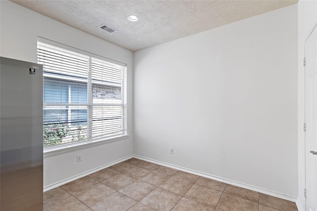 23307 W Pine Ivy Ln, Tomball, TX 77375 - unfurnished room featuring a textured ceiling, light tile patterned floors, and recessed lighting