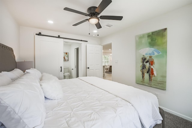 4330 Heite St, Houston, TX 77022 - bedroom with a barn door, recessed lighting, connected bathroom, ceiling fan, and carpet flooring