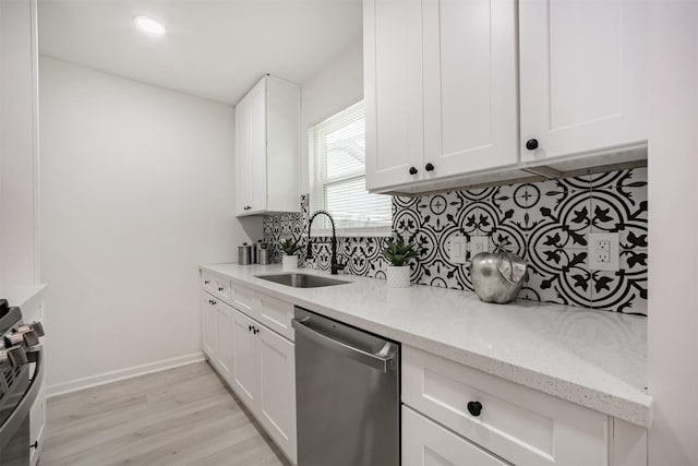 4330 Heite St, Houston, TX 77022 - kitchen featuring stainless steel appliances, decorative backsplash, light wood-type flooring, white cabinets, and light stone counters