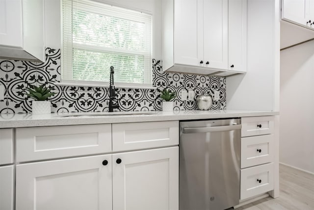 4330 Heite St, Houston, TX 77022 - kitchen featuring dishwasher, white cabinetry, and decorative backsplash