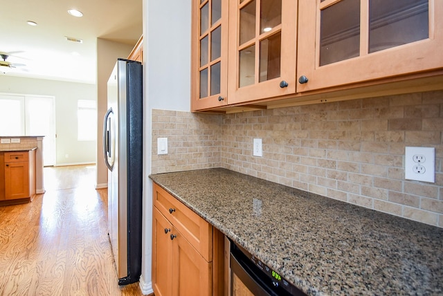 5615 Winsome Ln Unit C, Houston, TX 77057 - kitchen featuring freestanding refrigerator, dark stone counters, tasteful backsplash, ceiling fan, and recessed lighting