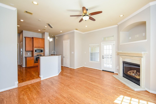 5615 Winsome Ln Unit C, Houston, TX 77057 - unfurnished living room featuring crown molding, ceiling fan, light wood-type flooring, recessed lighting, and a glass covered fireplace