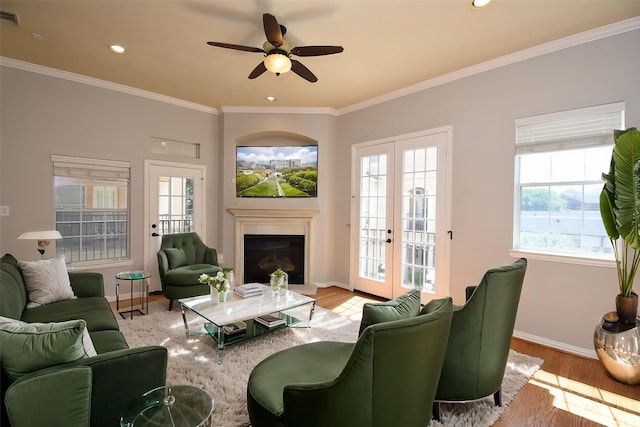 5615 Winsome Ln Unit C, Houston, TX 77057 - living area featuring wood finished floors, a ceiling fan, crown molding, a glass covered fireplace, and recessed lighting