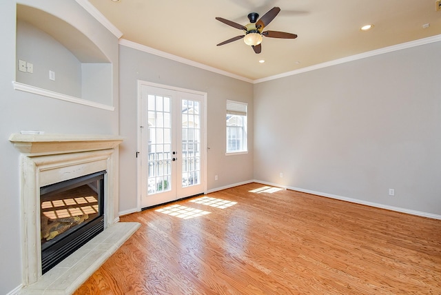 5615 Winsome Ln Unit C, Houston, TX 77057 - unfurnished living room featuring french doors, a fireplace with raised hearth, wood finished floors, ceiling fan, and crown molding