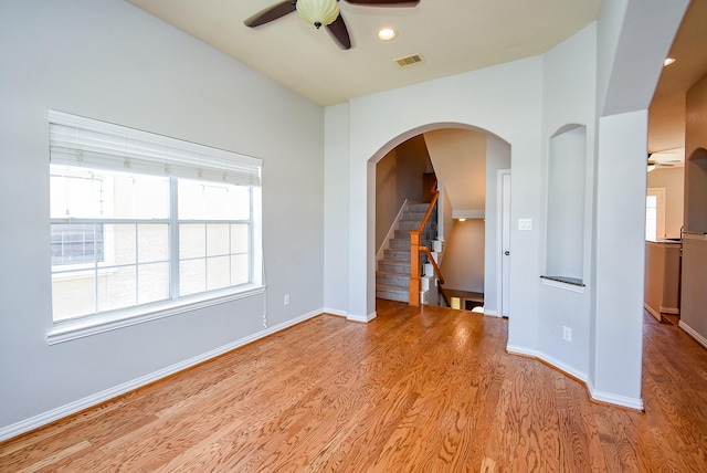 5615 Winsome Ln Unit C, Houston, TX 77057 - unfurnished room featuring a ceiling fan, wood finished floors, arched walkways, recessed lighting, and stairway