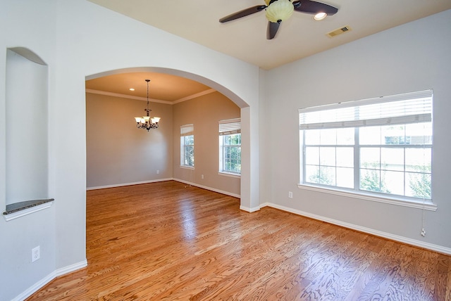 5615 Winsome Ln Unit C, Houston, TX 77057 - unfurnished room featuring arched walkways, light wood-style floors, a chandelier, a ceiling fan, and ornamental molding