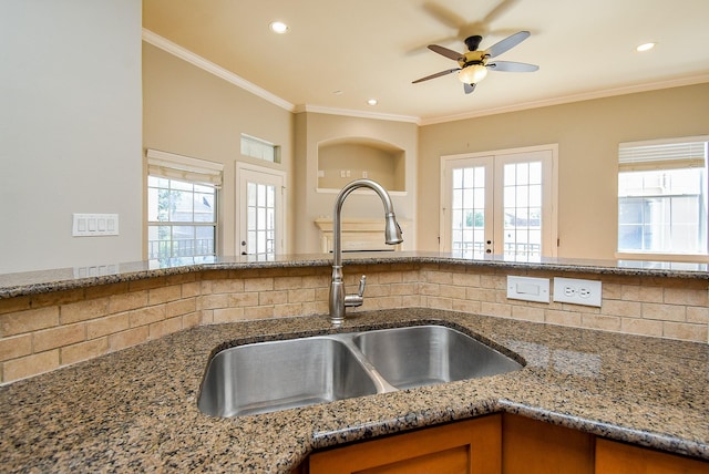 5615 Winsome Ln Unit C, Houston, TX 77057 - kitchen with stone counters, backsplash, healthy amount of natural light, ceiling fan, and ornamental molding