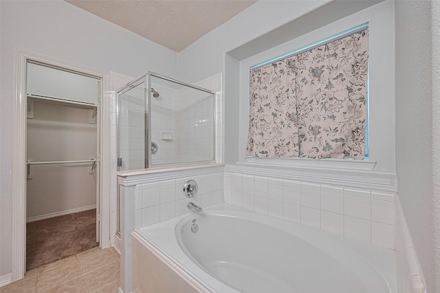 30606 S Sulphur Creek Dr, Magnolia, TX 77355 - full bathroom with a spacious closet, a garden tub, a stall shower, and tile patterned flooring