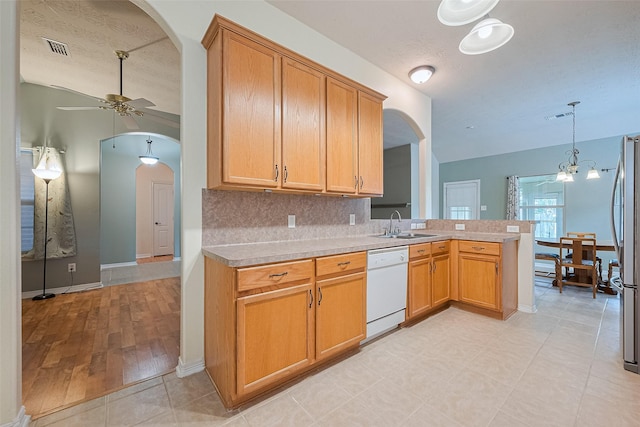 30606 S Sulphur Creek Dr, Magnolia, TX 77355 - kitchen featuring dishwasher, arched walkways, a peninsula, and a ceiling fan