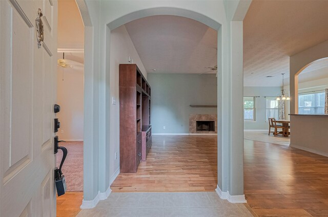 30606 S Sulphur Creek Dr, Magnolia, TX 77355 - entrance foyer featuring a fireplace, light wood-style flooring, and arched walkways