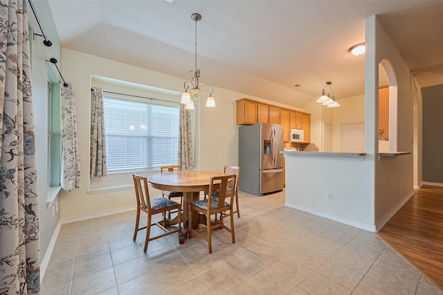 30606 S Sulphur Creek Dr, Magnolia, TX 77355 - dining room with light tile patterned floors, lofted ceiling, a chandelier, and a textured ceiling