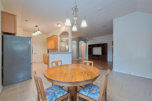 30606 S Sulphur Creek Dr, Magnolia, TX 77355 - dining room with arched walkways, a ceiling fan, a chandelier, and vaulted ceiling