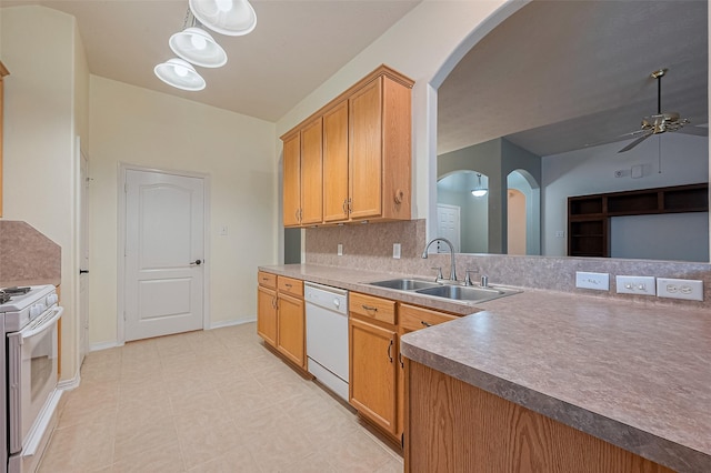 30606 S Sulphur Creek Dr, Magnolia, TX 77355 - kitchen with white appliances, arched walkways, ceiling fan, decorative backsplash, and light tile patterned flooring