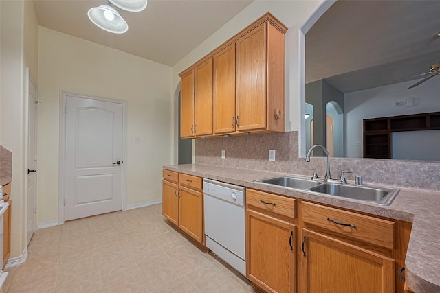 30606 S Sulphur Creek Dr, Magnolia, TX 77355 - kitchen with white dishwasher, arched walkways, brown cabinets, and decorative backsplash