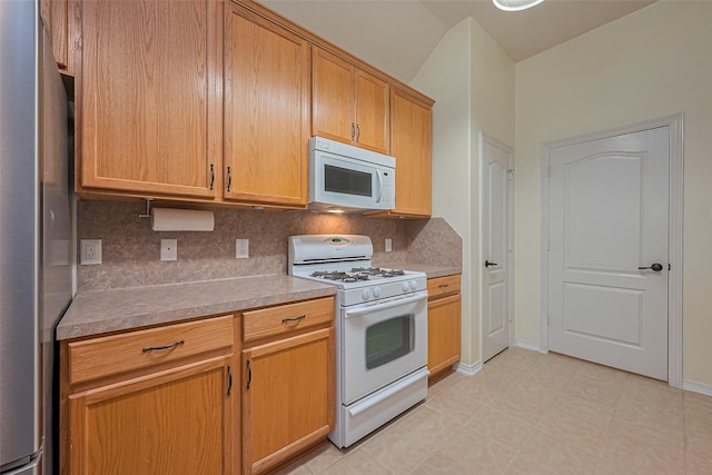 30606 S Sulphur Creek Dr, Magnolia, TX 77355 - kitchen featuring white appliances, light countertops, decorative backsplash, and light flooring